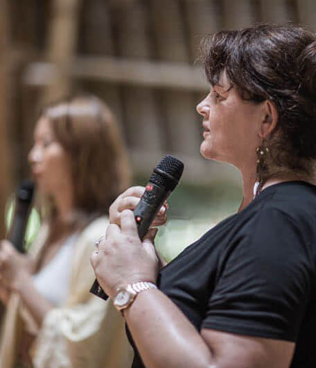 legacy-leadership-coaching Lisa-Wynn-with-a-microphone